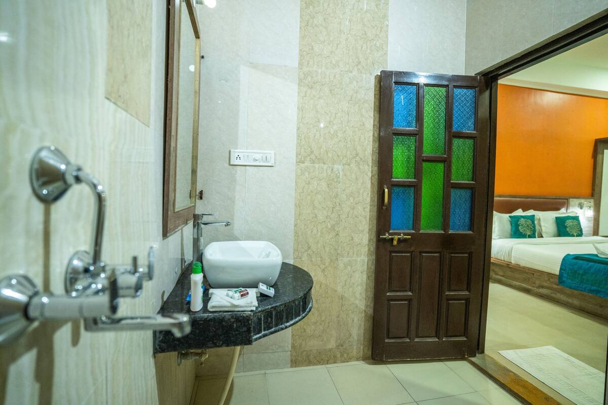 A bathroom with a sink, mirror, and shower.