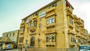 A historic building with ornate architecture, a swimming pool, and a restaurant.