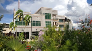 A modern building with multiple floors, large windows, and a balcony. - Golden Zambezi Lodge (Lusaka)
