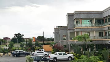 A multi-story building with a modern architectural design, featuring balconies and large windows.
