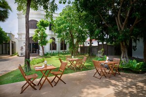Enjoy al fresco dining amidst lush surroundings and traditional architecture.