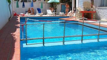 Seasonal outdoor pool, pool umbrellas, pool loungers