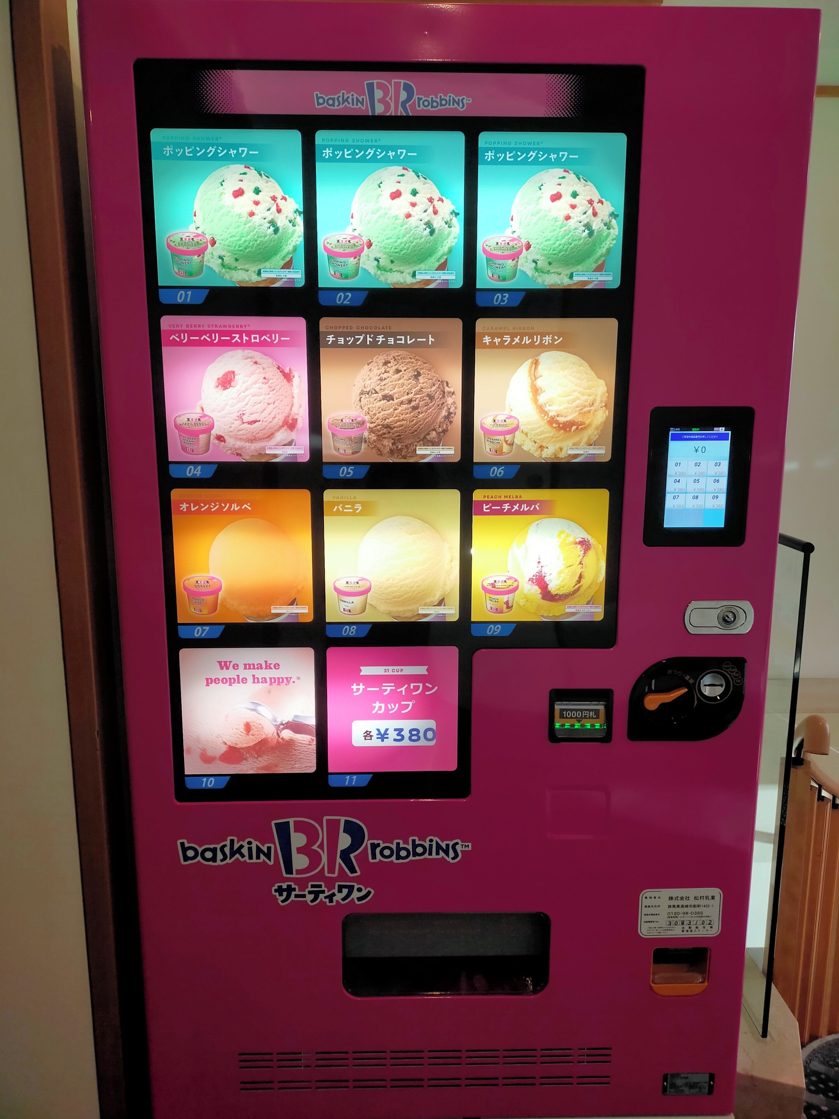 A pink vending machine with multiple ice cream options, a digital payment screen, and a 31 cup capacity label.