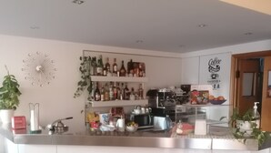 A modern kitchen with a central island, stainless steel appliances, and a variety of kitchenware.