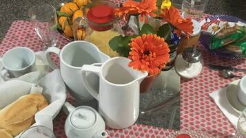 A table set with various dishes, including a pitcher, cups, and a plate of food.