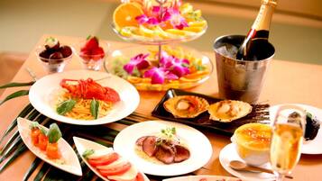 A table set with various dishes including seafood, a bottle of champagne, and a dessert.