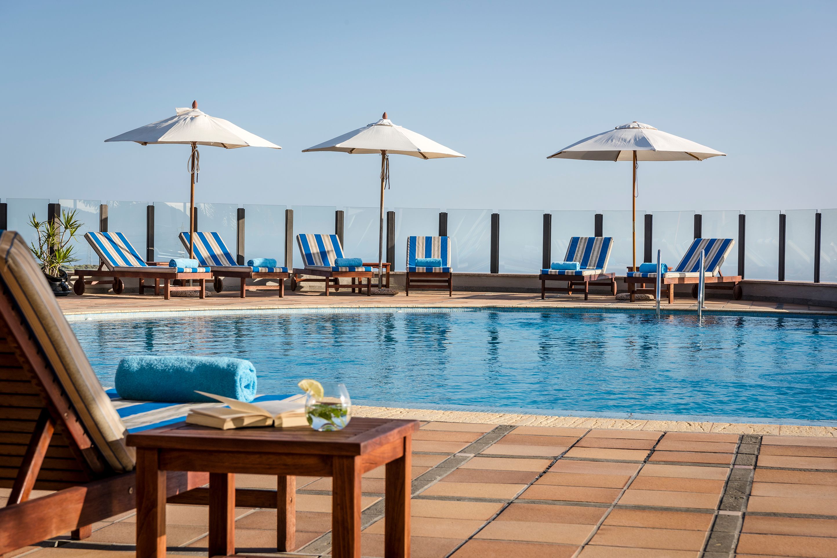 outdoor pool, pool umbrellas, pool loungers