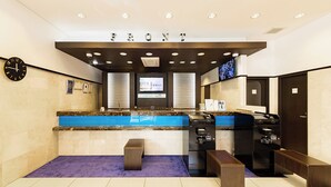 A reception area with a marble counter, a clock, a television, and a sign that reads "FRONT". - Toyoko Inn Kintetsu Yokkaichi-eki Kita-guchi (Yokkaichi)