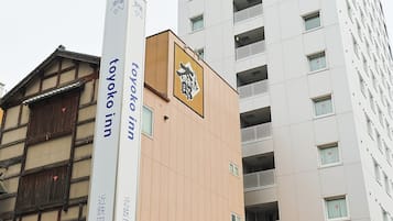 A building with signage for 'Toyoko Inn' and a traditional Japanese architectural style.