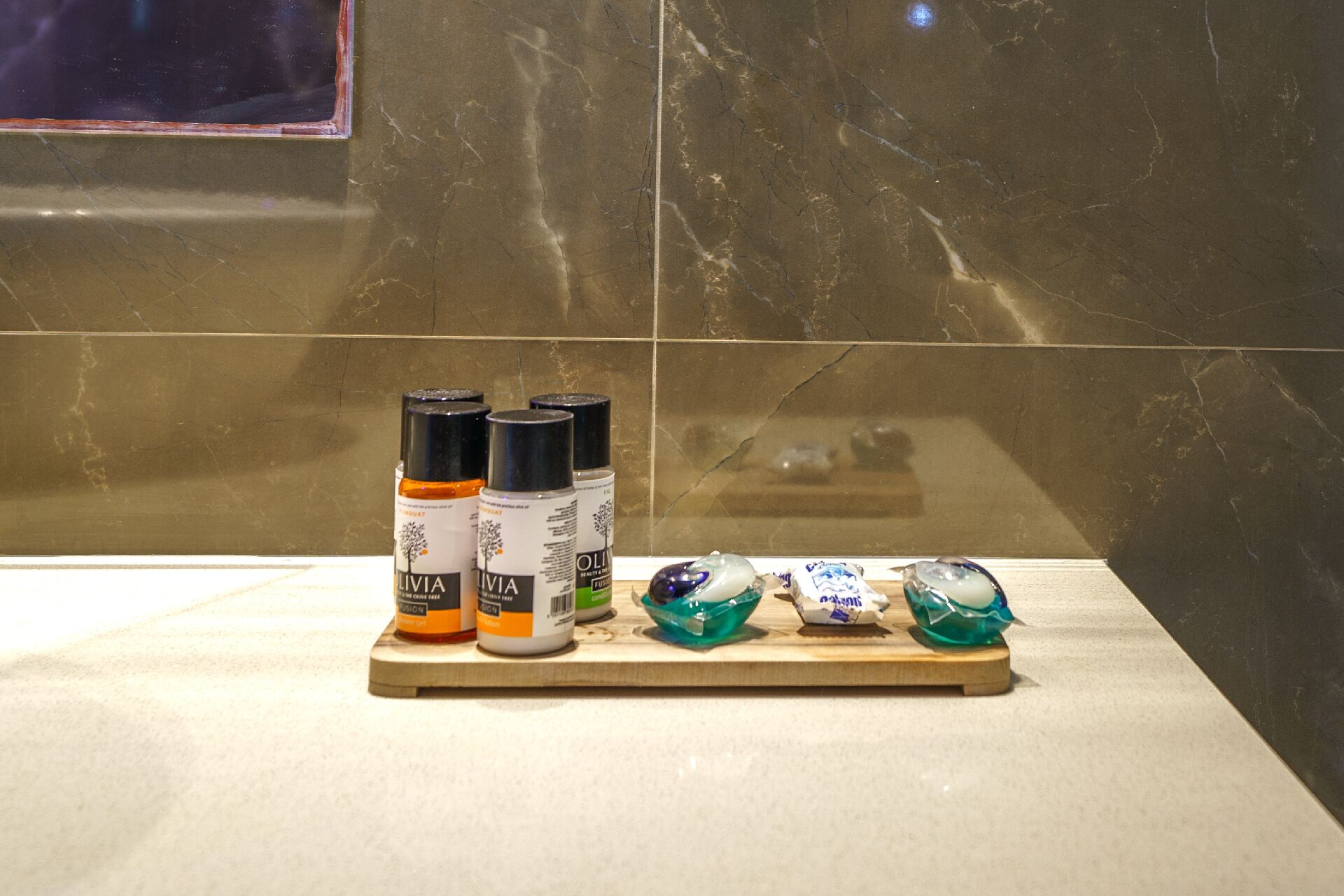 A bathroom counter with toiletries and decorative items.