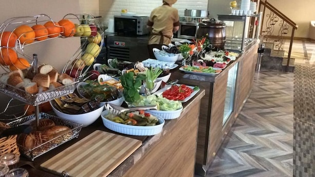 A buffet with various food items including fruits, vegetables, and bread. - Otel Vona Ordu (Ordu)