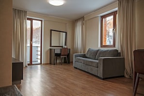 Suite, 1 Bedroom | Living room | 50-inch flat-screen TV with cable channels, LCD TV