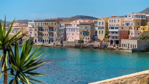 A coastal town with colorful buildings along the waterfront. - Electra Syros Boutique Hotel (Syros)