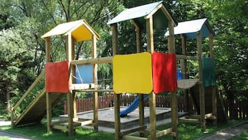 Explore the fun of this park's play structure, featuring a climbing frame and slide.