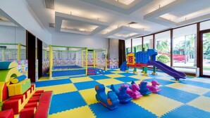 A play area with a slide, soft play equipment, and a netted play structure. - Grand Soluxe Hotel And Resort Sanya (Sanya)
