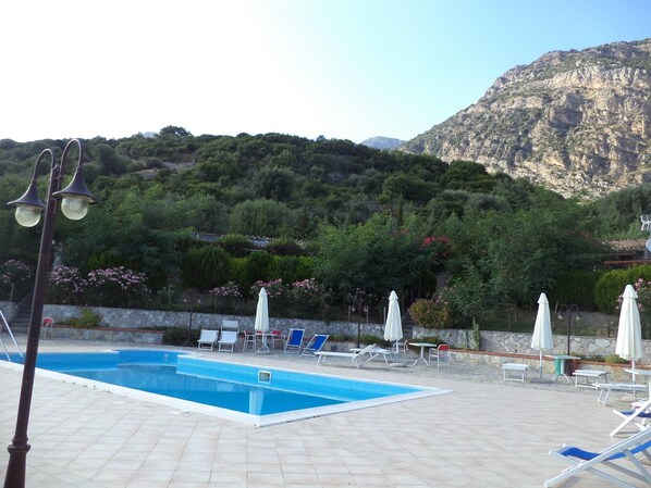 Seasonal outdoor pool, pool umbrellas, pool loungers