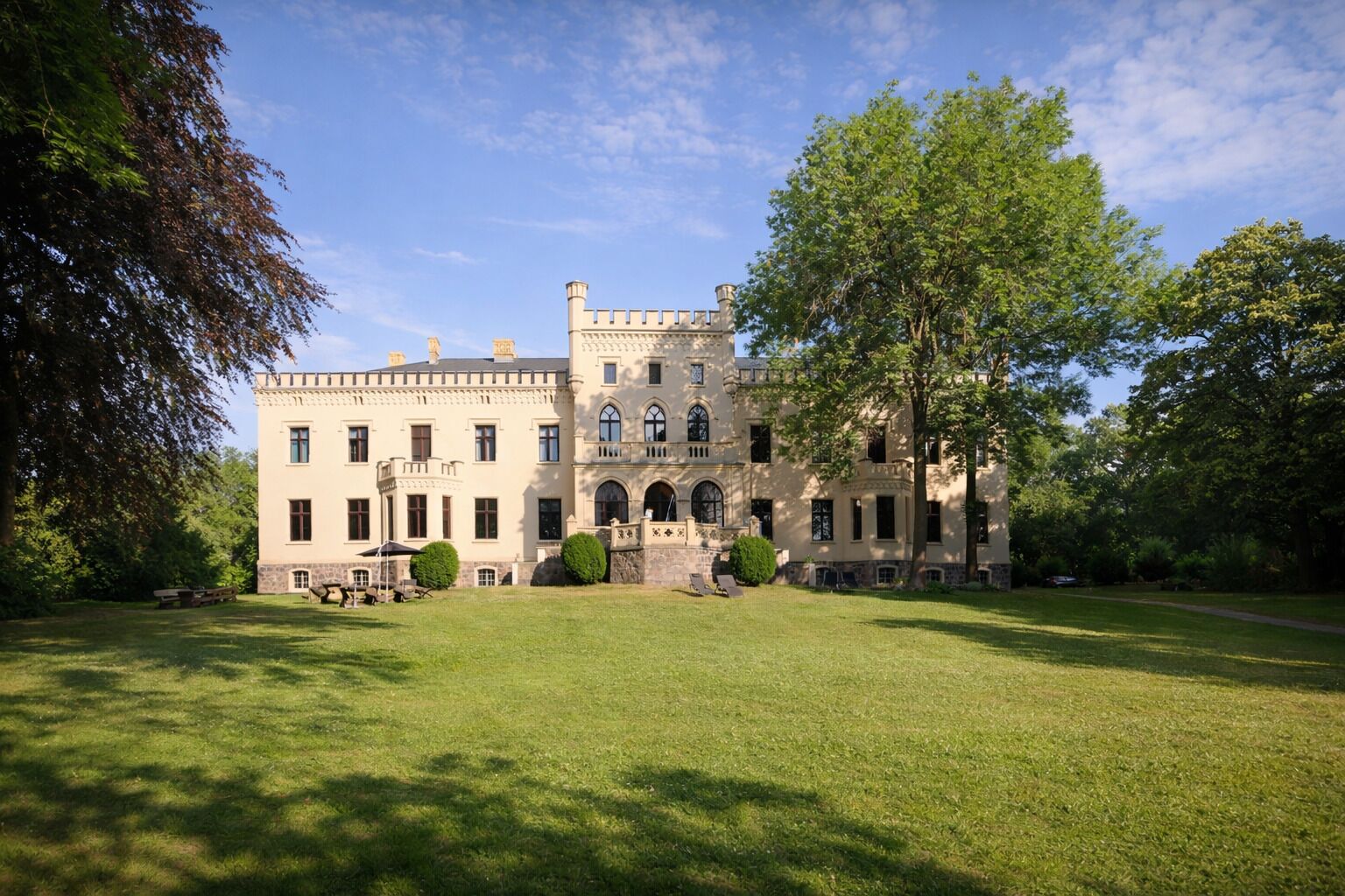 A large, historic building with a symmetrical facade, multiple windows, and a central entrance.
