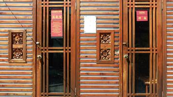 Un edificio in legno con due porte, ognuna con una targa che indica una sauna e una stanza vapore.