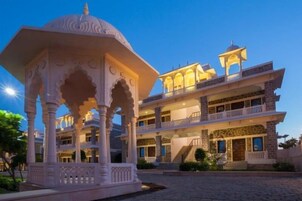 A multi-story building with a traditional architectural style, featuring balconies and a central courtyard.