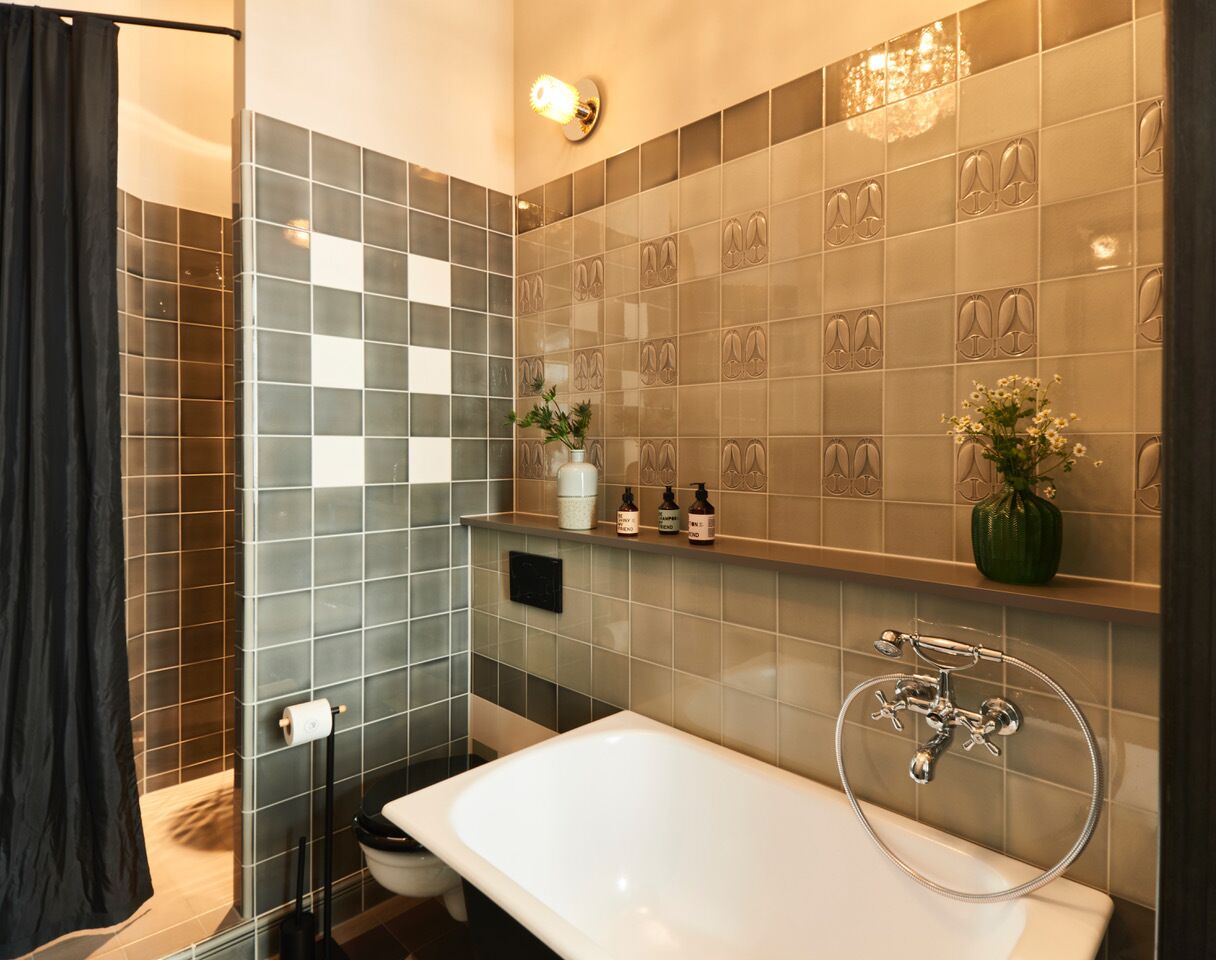 A modern bathroom with a large bathtub, a shower area, and a vanity with a mirror.