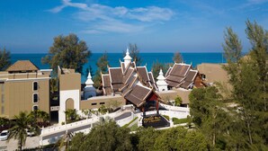 A resort with traditional architecture, a beach view, and a sign for 'Majapalu Resort'. - Maikhao Palm Beach Resort (Mai Khao)