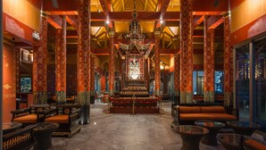 A traditional interior with ornate columns, a central altar, and seating areas. - Maikhao Palm Beach Resort (Mai Khao)