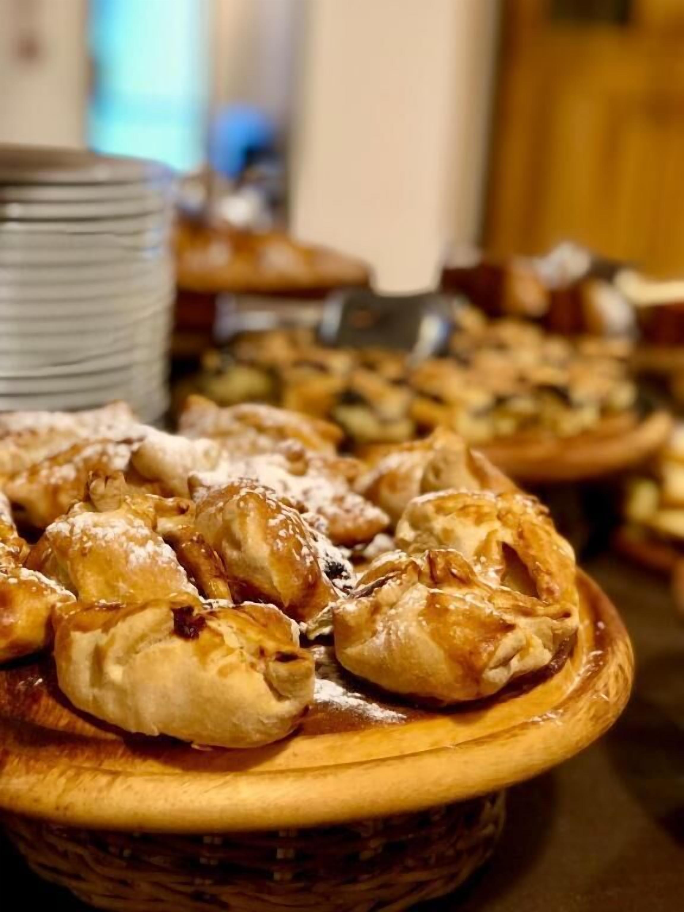 A buffet table with various pastries and desserts.