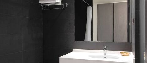 A modern bathroom with a bathtub, a sink, and a mirror.