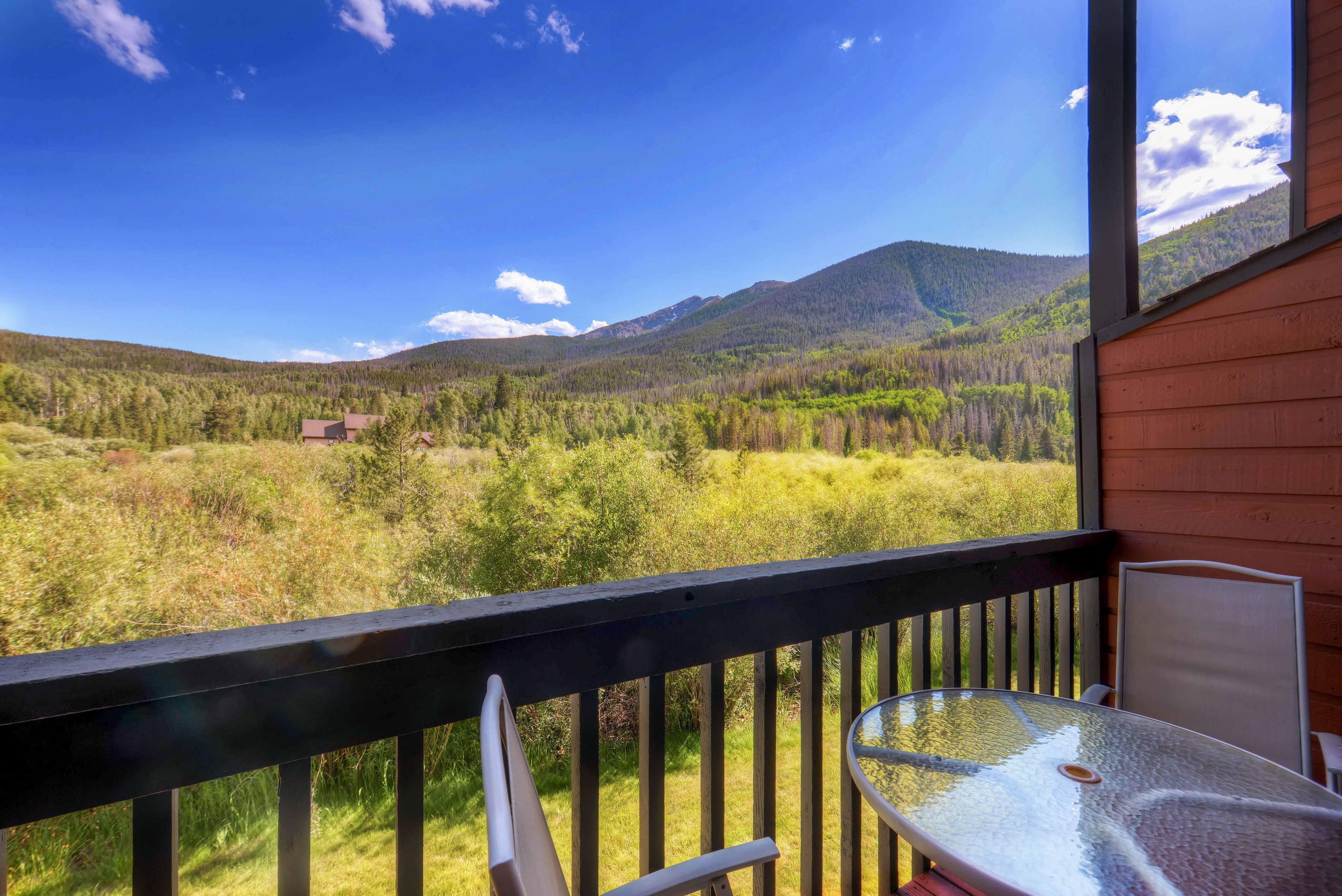 A balcony with a clear view of a mountainous landscape.