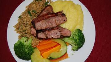 A plate with grilled meat, mashed potatoes, quinoa, broccoli, carrots, and avocado.