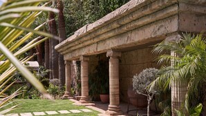 A classical building with columns and a garden. - Atlantica Bay Hotel - Adults Only (Limassol)