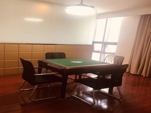 A room with a pool table, four chairs, a ceiling light, and a window with curtains. - GreenTree Inn HeFei HuangShan Road DaXiDi 1912 Express Hotel (Hefei)