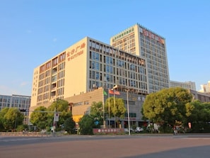 A multi-story hotel with a modern architectural design, featuring a prominent signage on the facade.