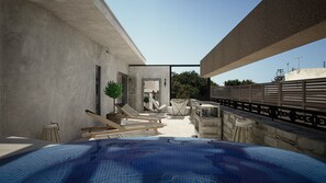 A modern outdoor pool area with a view of the city, a seating area, and a pathway leading to a building entrance. - Elakati Luxury Boutique Hotel - Adults Only (Rhodes)