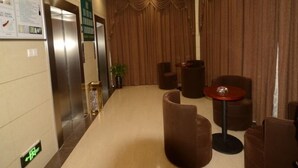 A lobby with a reception desk, seating area, and an elevator. - GreenTree Inn Hefei Shushan District Guichi Road Express Hotel (Hefei)