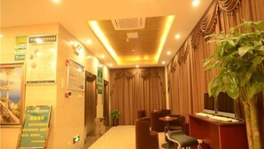 A hotel lobby with a reception desk, seating area, and informational posters on the walls. - GreenTree Inn Hefei Shushan District Guichi Road Express Hotel (Hefei)