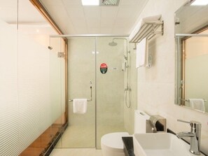 A modern bathroom with a glass-enclosed shower, a white sink, and a large mirror. - Greentree Guangxi Guilin Yangshuoxi Street Express (Nanning)