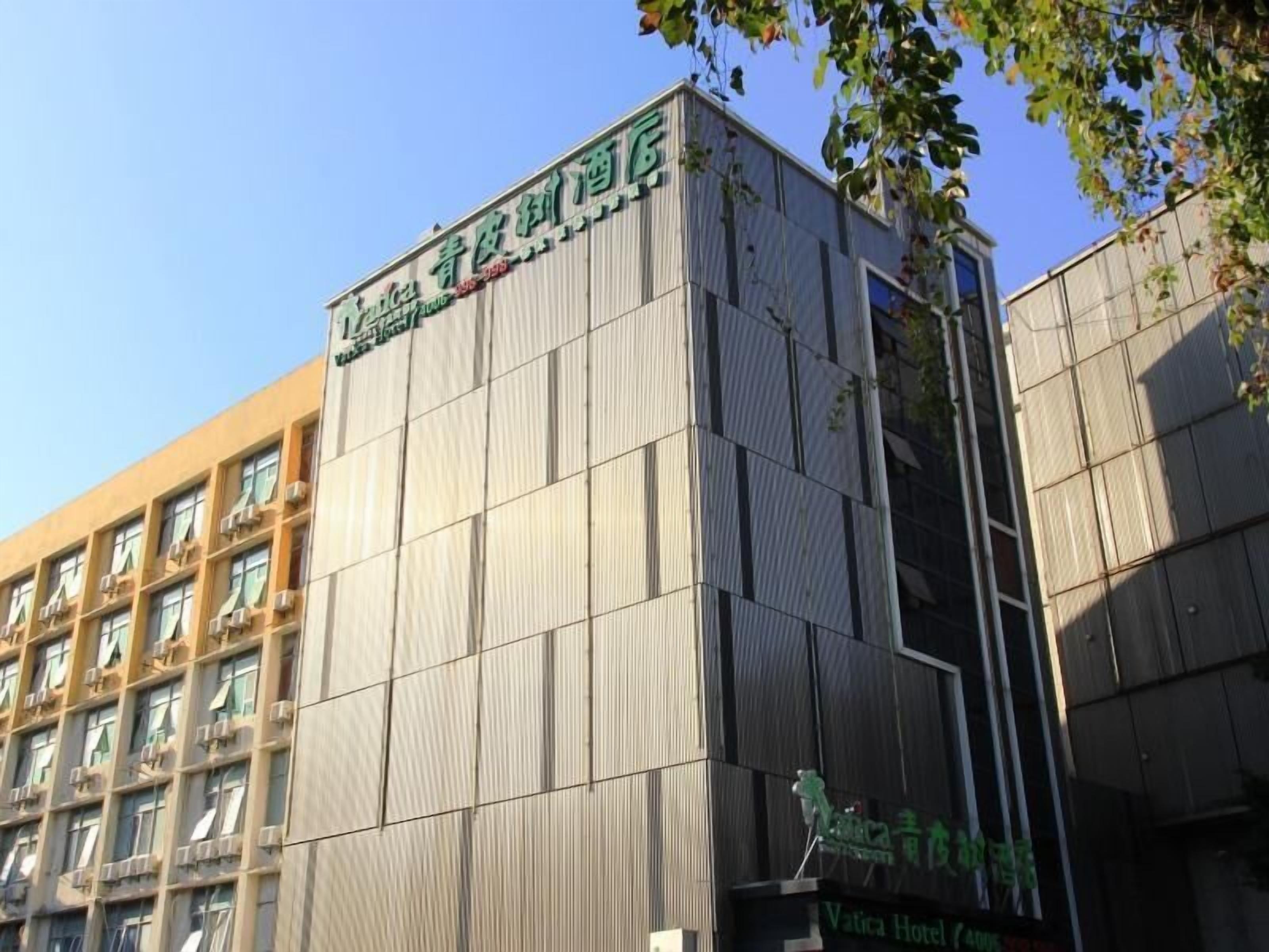 A modern building with a sign that reads "Vatica Hotel."