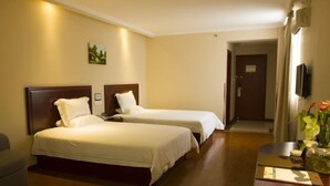 A hotel room with two single beds, a small desk, a chair, and a television. - GreenTree Inn Haikou Longhua District Guomao Hotel (Haikou)