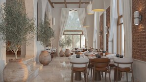 A spacious dining area with multiple tables and chairs, large vases, and a view through a window with curtains. - InterContinental Durrat Al Riyadh Resort & Spa by IHG (Riyadh)