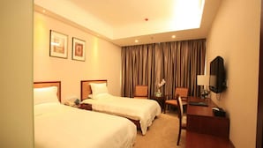A hotel room with two beds, a desk, a chair, a television, and a window with curtains. - Greentree Inn Beijing Yanqing Railway Station (Yanqing)