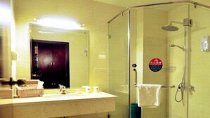 A bathroom with a glass-enclosed shower, a sink with a mirror, and a toilet. - Greentree Inn Beijing Yanqing Railway Station (Yanqing)