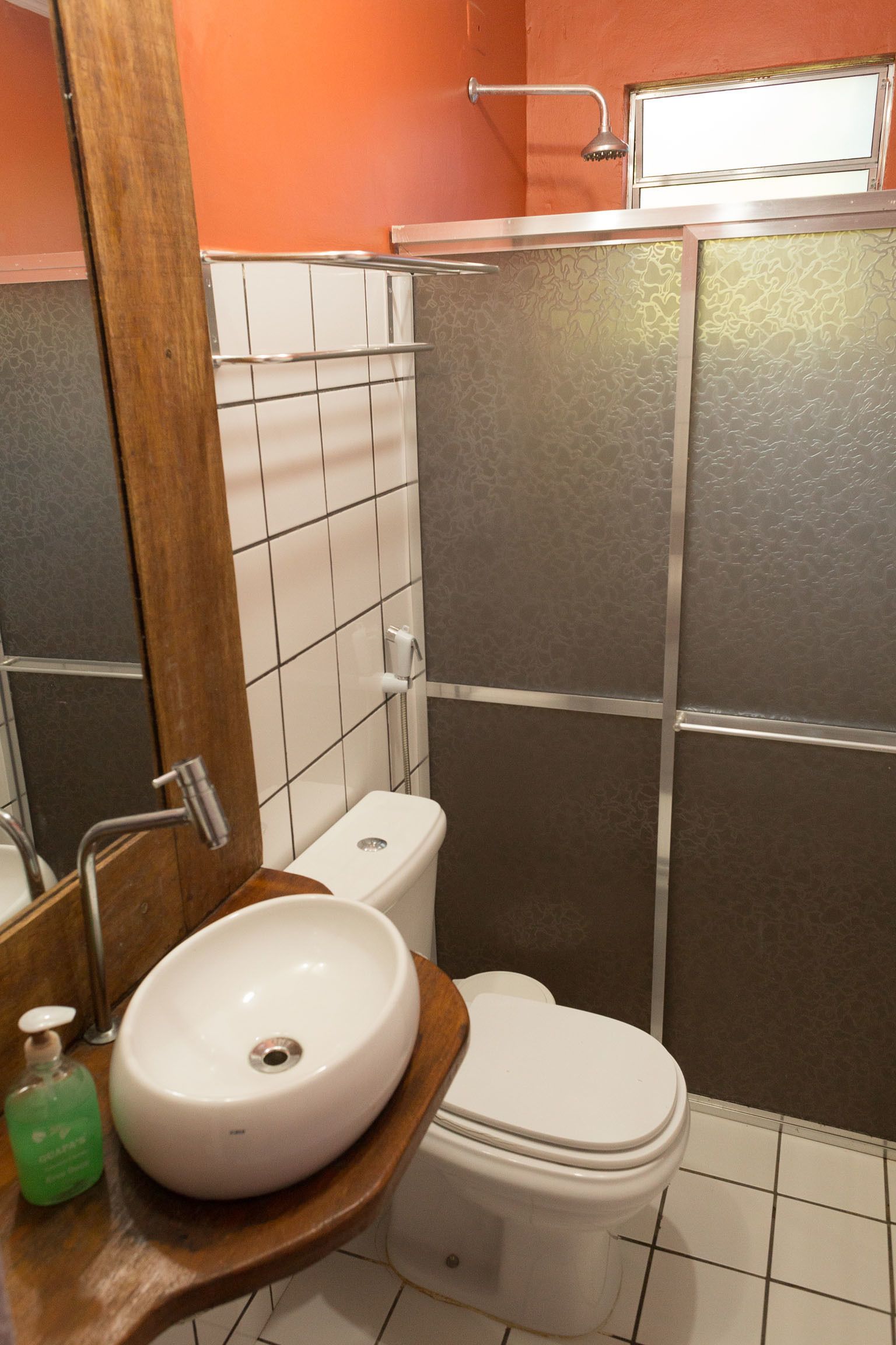 Een badkamer met een wit wastafel, toilet en douche.