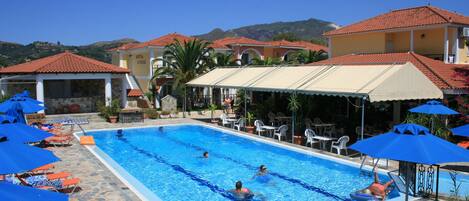 Seasonal outdoor pool, open 9:30 AM to 7:00 PM, pool loungers