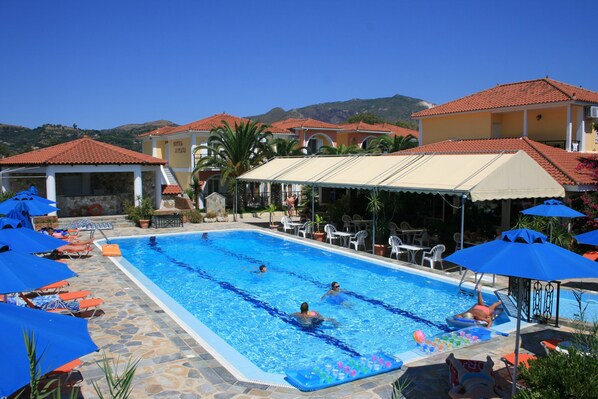 Seasonal outdoor pool, open 9:30 AM to 7:00 PM, pool loungers