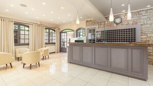 A modern kitchen with a granite countertop, a built-in stove, and a stone backsplash. There are three pendant lights hanging above the counter. - Oasis (Corfu)