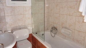 Ein Badezimmer mit Toilette, Waschbecken und Badewanne.