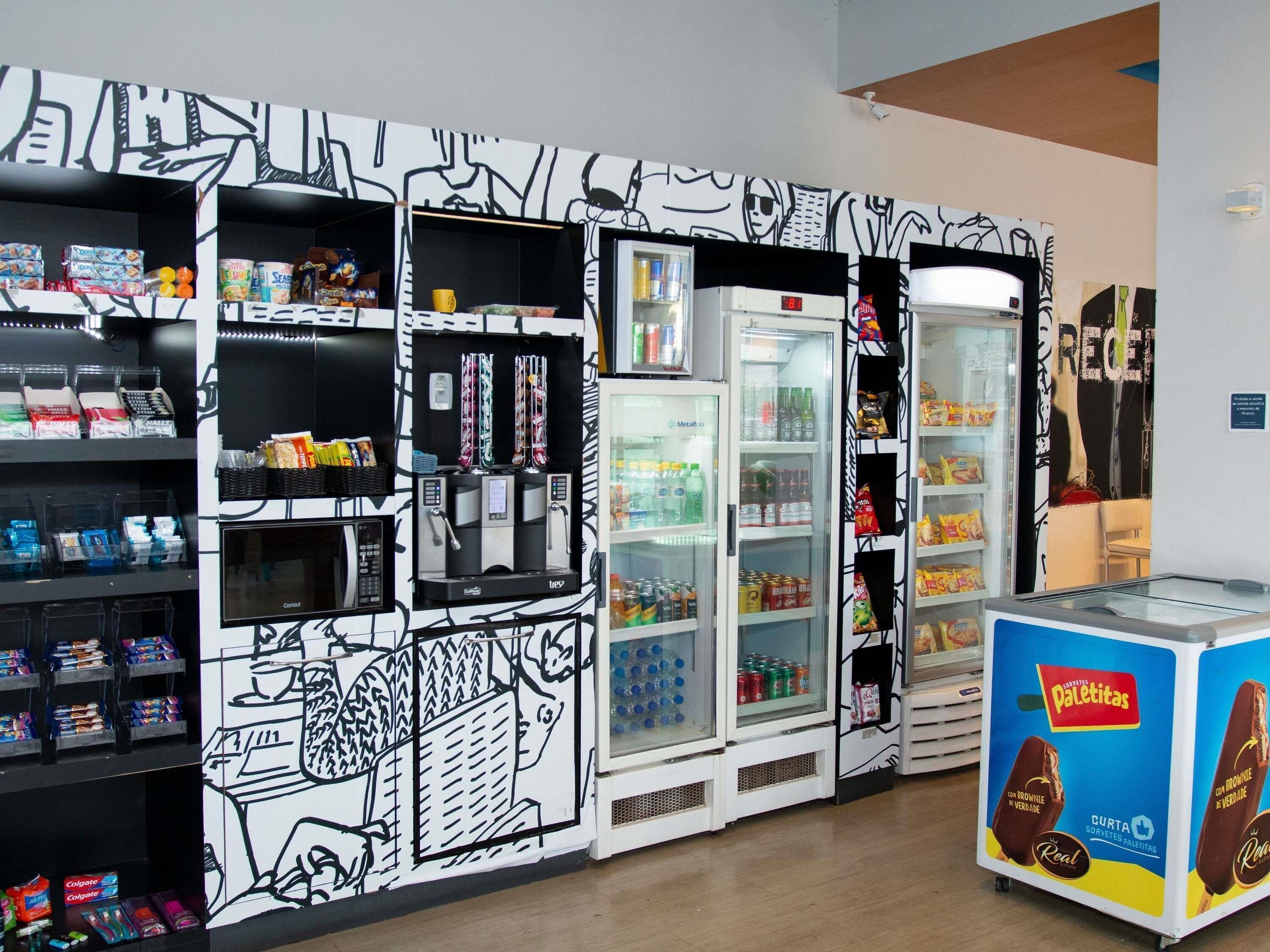 A vending machine with snacks and drinks, a refrigerated display case, and a chocolate bar display.