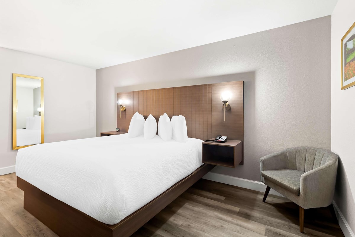 Premium bedding, desk, laptop workspace, blackout drapes