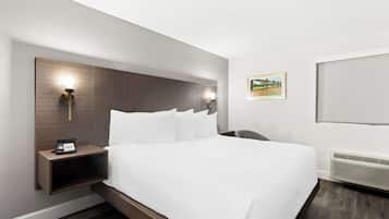 Premium bedding, desk, laptop workspace, blackout drapes